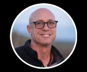 Dan Perata smiling outdoors, promoting training and coaching services.
